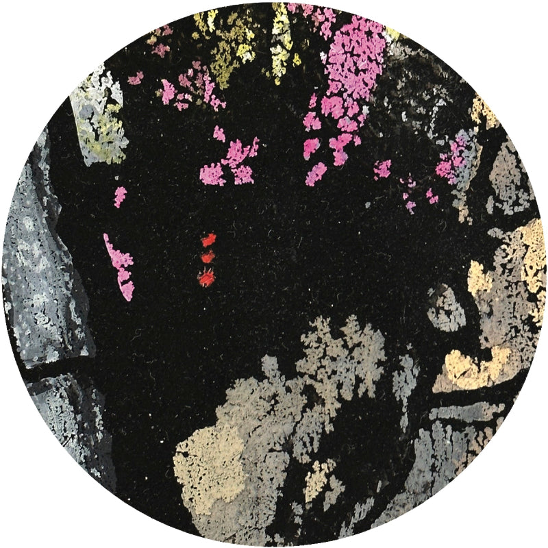 Round coaster with floral pattern on a black background