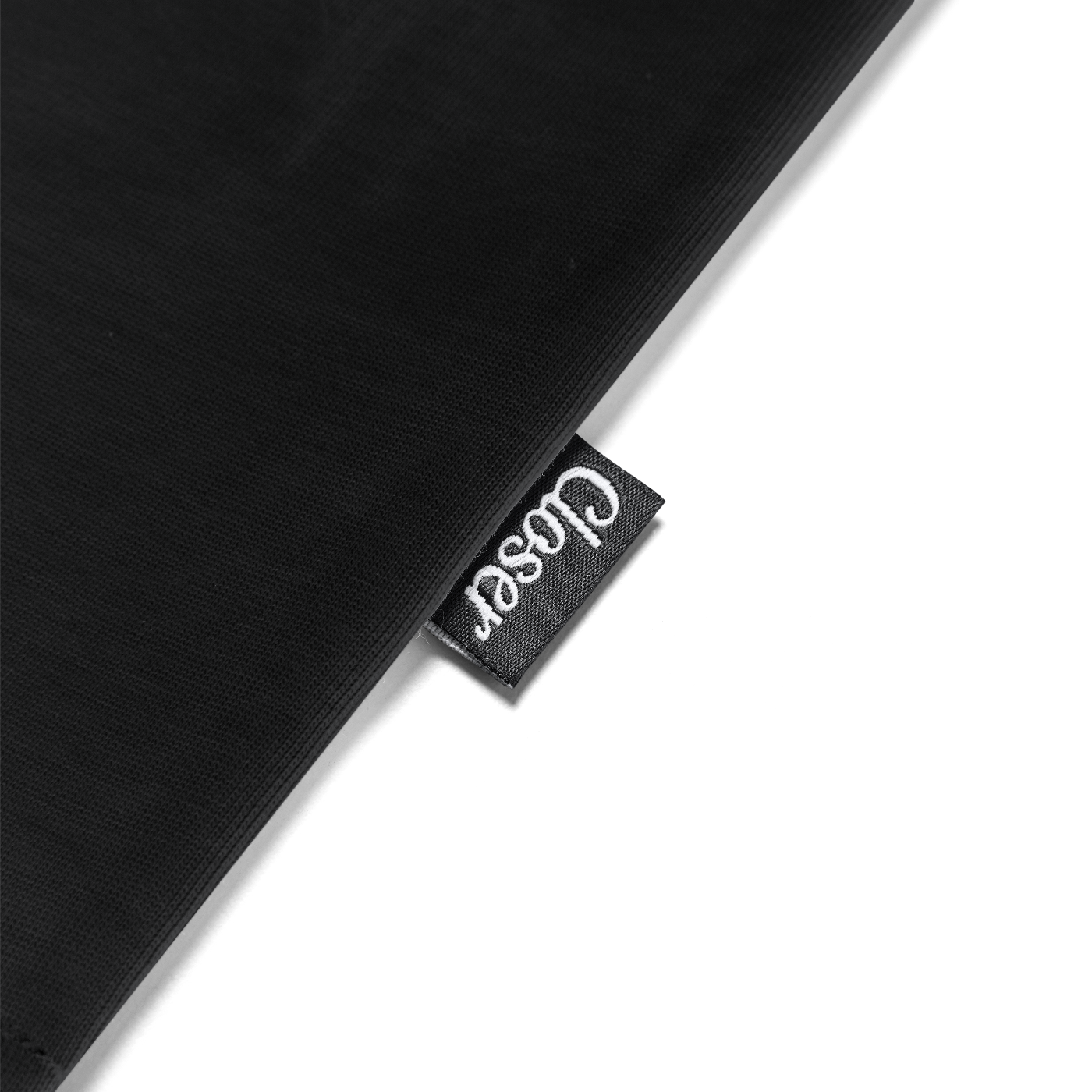 Black fabric with a 'Coser' brand tag on a white background