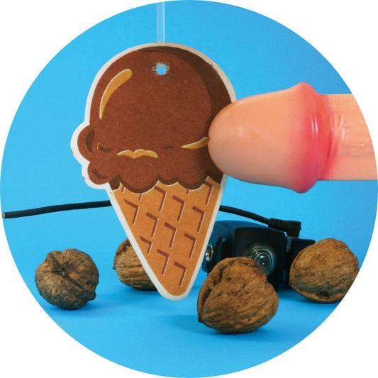 Ice cream cone-shaped air freshener with a hand holding it against a blue background