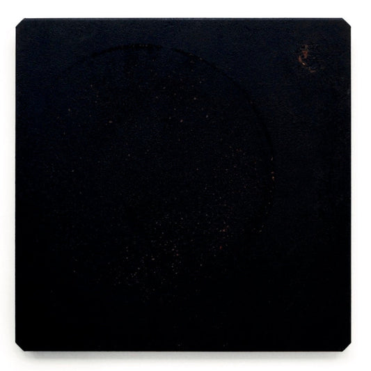 Black square tile with a circular cutout on a white background