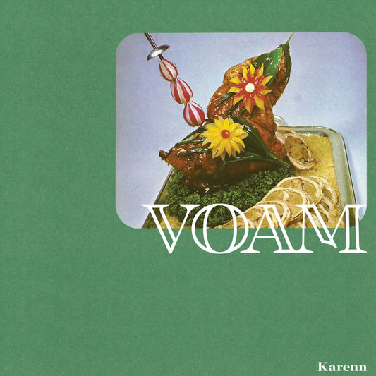 Artistic depiction of a dish with flowers on a green background, featuring the brand 'VOAM'.